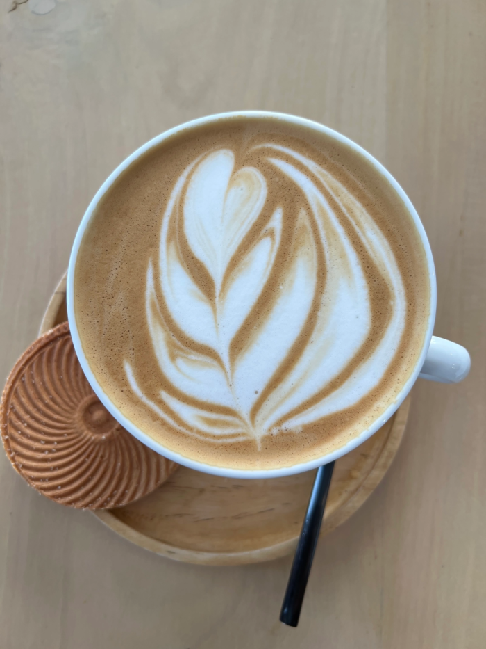 Latte art at home with tulip-shaped milk foam poured into freshly brewed espresso